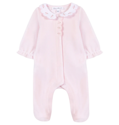 Tartine et Chocolat Baby Girls’ Velvet Peter Pan Collar Pajamas—a pink long-sleeve sleeper featuring a charming Peter Pan collar, delicate embroidered flowers, ruffled cuffs, and footed legs—is displayed against a white background.