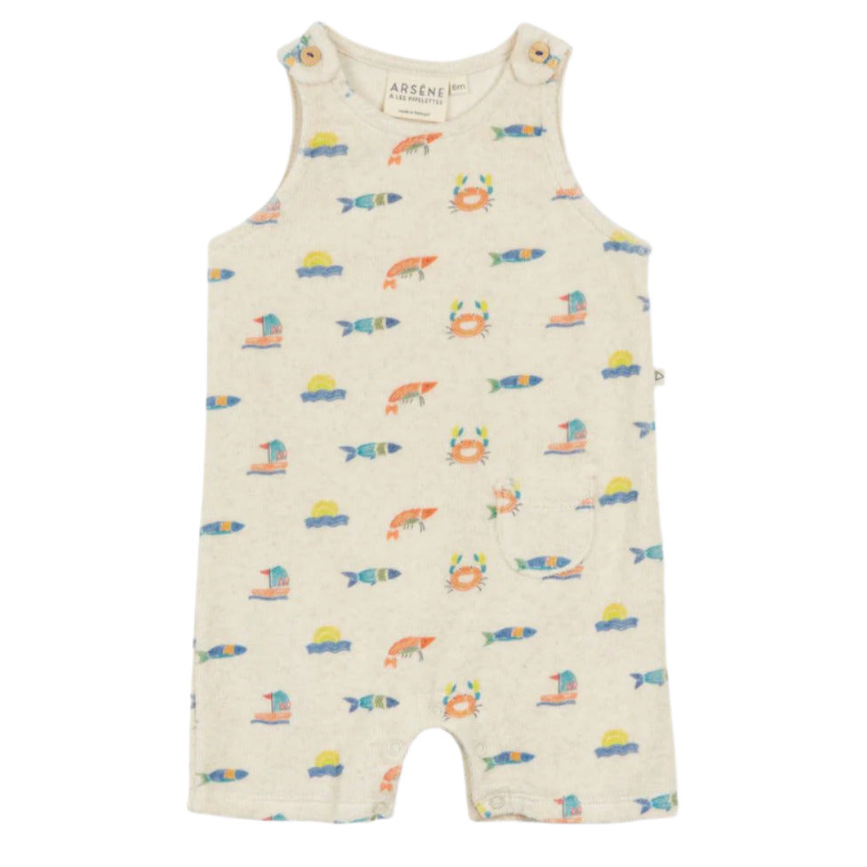 The Arsene & Les Pipelettes Baby Fedolin Terry Romper is beige with colorful fish, crab, and sailboat prints. This sleeveless romper features shoulder buttons and a small front pocket.