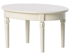 An ivory-colored, oval-shaped wooden Maileg Dining Table with four carved legs, ideal for a charming mouse castle dining setup with your Maileg mice.