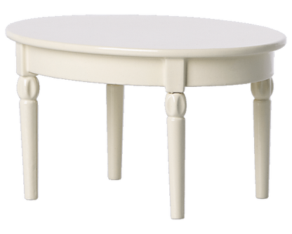 An ivory-colored, oval-shaped wooden Maileg Dining Table with four carved legs, ideal for a charming mouse castle dining setup with your Maileg mice.