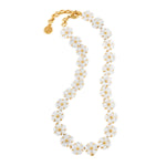 The Juliska Capucine De Wulf Mermaid Garden Petite Riviere Convertible Necklace features hand-carved detailing and white floral beads with gold accents, arranged in a single strand for a daisy chain effect.