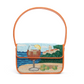 The Staud Tommy Beaded Bag features coastal and cocktail motifs, an orange strap, hand-beaded details with lemons and limes, seaside scenery, and a secure magnetic snap closure.