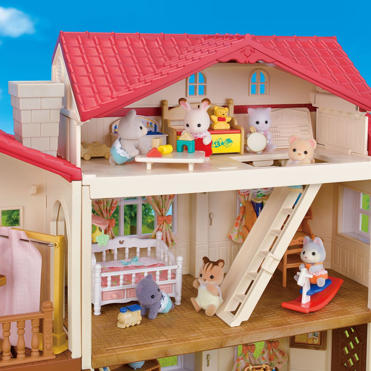 The Country Home-Secret Attic Playroom by Calico Critters is a charming dollhouse, complete with members of the Chocolate Rabbit family in various rooms—including a delightful playroom, nursery, and living area—all beautifully furnished with miniature toys and furniture.