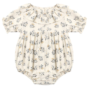 The Quincy Mae Baby Girls’ Collared Romper features a cream hue with puff sleeves, a ruffled collar, elastic leg openings, and a delicate floral print in grey and yellow tones.