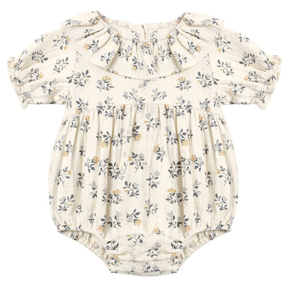 The Quincy Mae Baby Girls’ Collared Romper features a cream hue with puff sleeves, a ruffled collar, elastic leg openings, and a delicate floral print in grey and yellow tones.