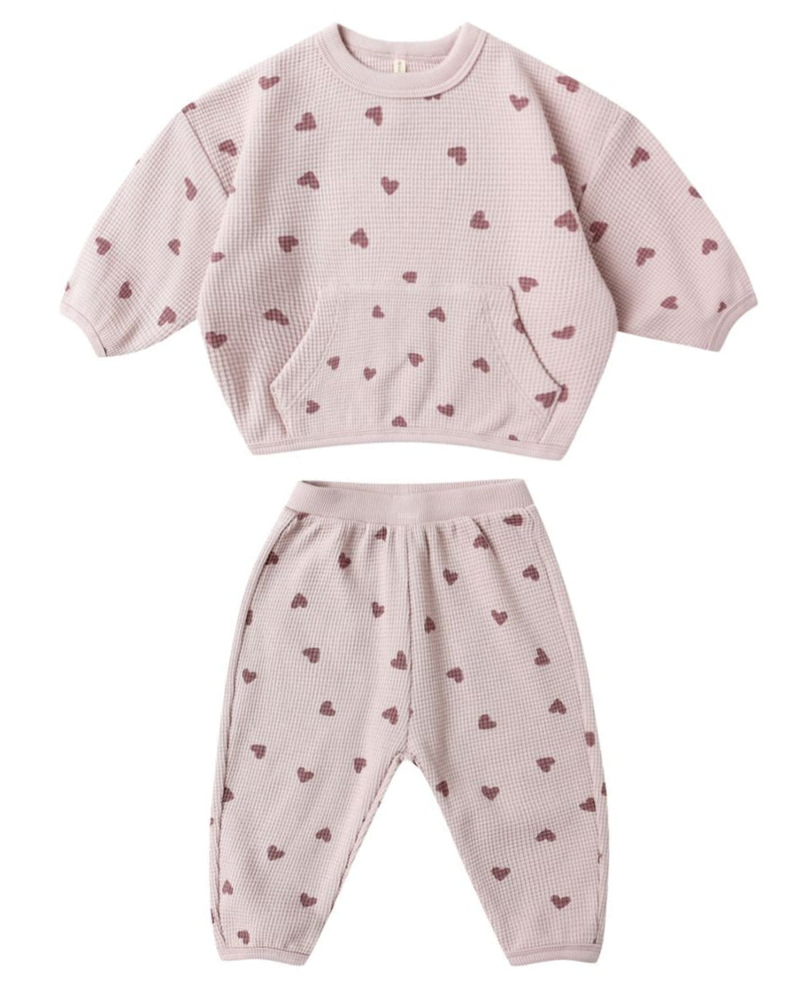 Cozy up in the Quincy Mae Baby Girls' and Girls' Waffle Slouch Set—a pink, long sleeve top and matching pants with maroon heart patterns. The waffle-knit set features a front pocket and ribbed cuffs for comfort.