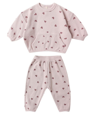 Cozy up in the Quincy Mae Baby Girls' and Girls' Waffle Slouch Set—a pink, long sleeve top and matching pants with maroon heart patterns. The waffle-knit set features a front pocket and ribbed cuffs for comfort.