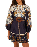 Farm Rio Golden Nature Belted Mini Dress in navy blue, cream, and yellow botanical print with long puff sleeves, a button-down front, and a circular buckle belt.