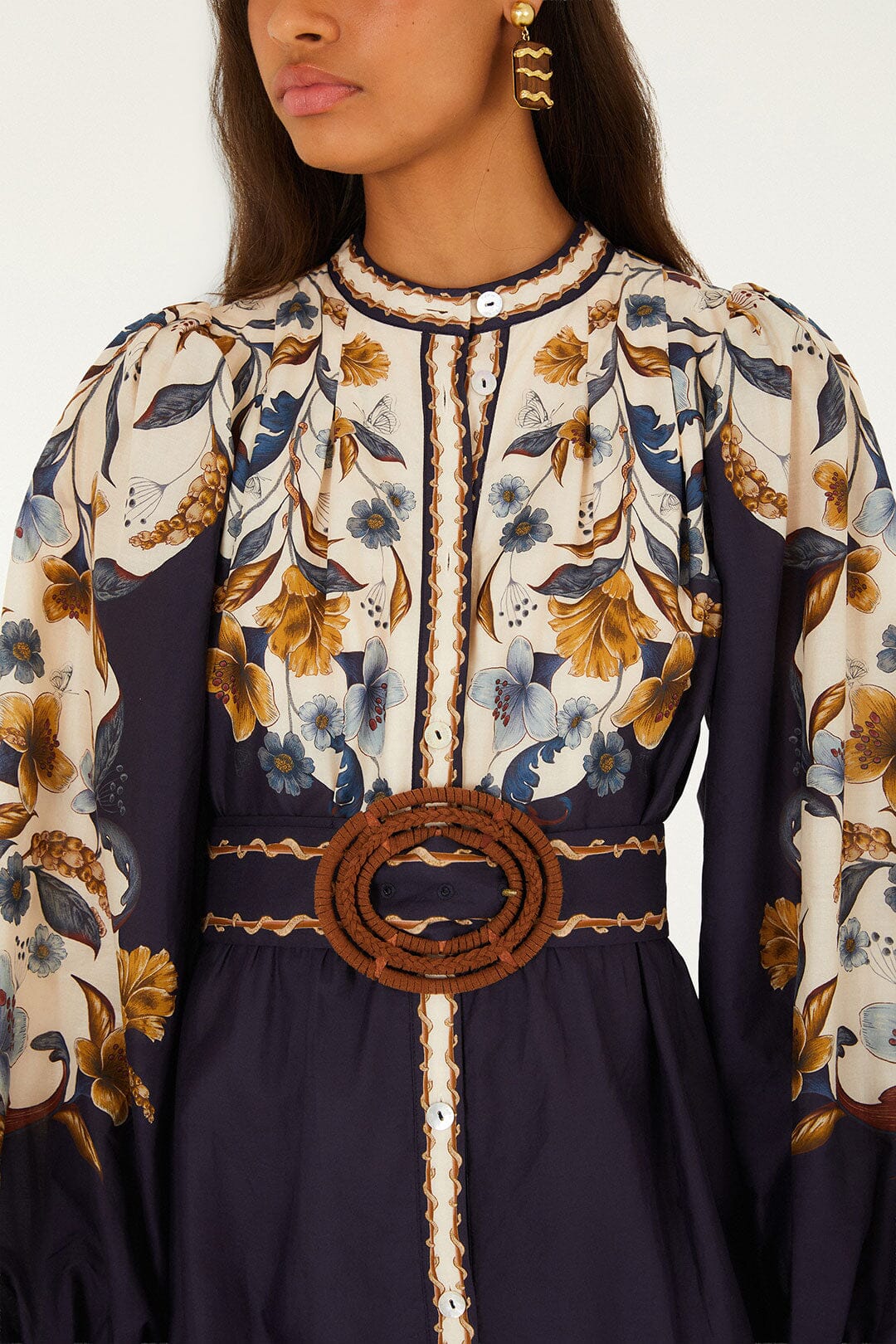 Farm Rio Golden Nature Belted Mini Dress, a long-sleeved floral mini dress in cream and navy, featuring a button-down front and a circular brown rope belt at the waist.