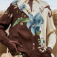 Millena Winter White Shirt by FARM Rio, a long-sleeved button-down featuring a brown and cream color-blocked design with a large blue botanical print of flowers and pineapples.