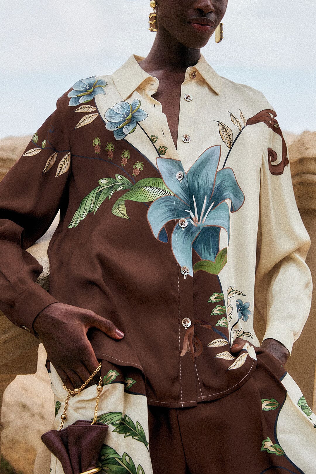 Millena Winter White Shirt by FARM Rio, a long-sleeved button-down featuring a brown and cream color-blocked design with a large blue botanical print of flowers and pineapples.