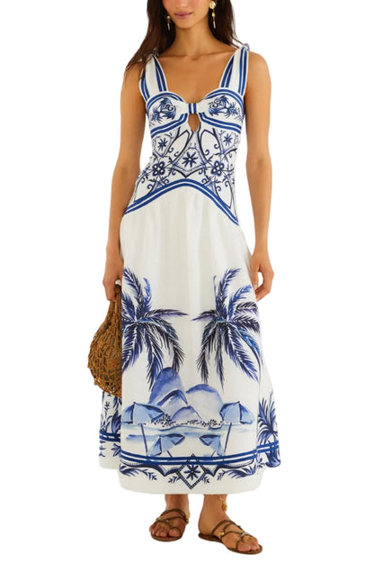 A woman wears the Farm Rio Wonderful City Mix Off White Maxi Dress with a blue tropical beach print, paired with sandals and a woven bag.