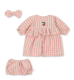 The Konges Slojd Doll Clothes Set by Konges Slojd is a charming pink and white checkered baby dress with cherry embroidery, matching bloomers, and a sweet bow headband.