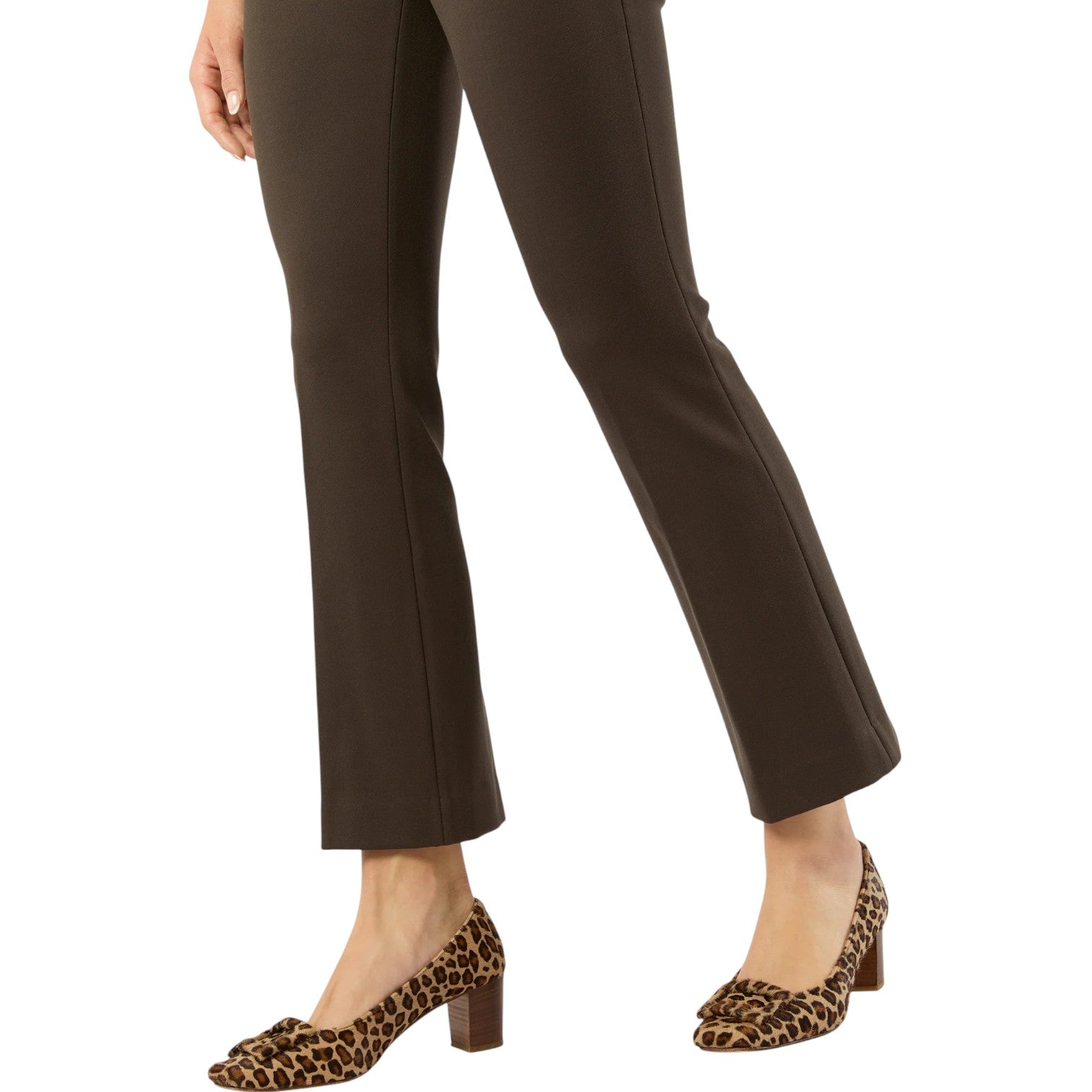 A woman shown from the waist down wears Ann Mashburn's Faye Flare Cropped Pant in dark brown with an elastic waist, paired with leopard print block-heeled shoes, against a white background.