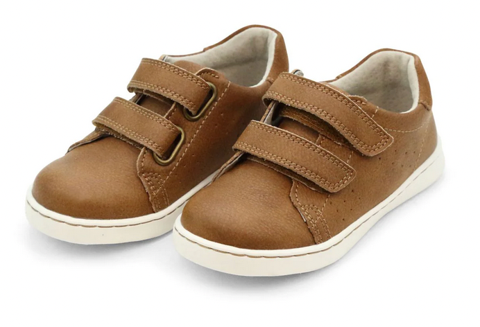 The Boys' Kyle Double Strap Sneaker by L'Amour Shoes features a brown design, white soles, two hook-and-loop straps per shoe, and a cushioned memory foam leather sockbed for all-day comfort.