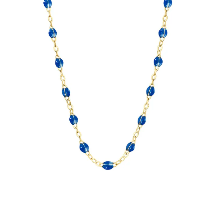 The Gigi Clozeau Classic Gigi Necklace 19.7", crafted with 18 carat Yellow Gold, showcases a delicate gold chain adorned with evenly spaced blue beads, embodying the timeless elegance of Gigi Clozeau design.