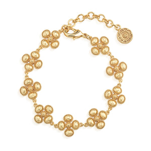 The Berry Clover Linear Bracelet by Juliska Capucine De Wulf features clusters of small round beads, an adjustable chain, lobster clasp, and a golden clover medallion—an ideal lucky charm for your bracelet stack.
