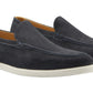 The Peter Millar Excursionist Nubuck Venetian Loafer in dark blue features water-resistant nubuck, white rubber soles, and a light brown interior lining, showcased against a white background.