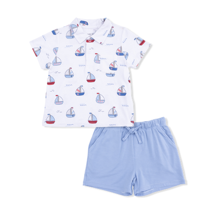 Angel Dear Baby Boys’ and Boys’ Polo with Casual Short, featuring a white short-sleeve sailboat print polo shirt paired with light blue drawstring Organic Cotton Muslin shorts, laid flat on a white background.
