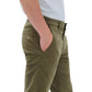 A person wearing Rag & Bone Fit 2 Stretch Twill Chino in olive green and a white shirt stands in profile with one hand in their pocket against a white background.
