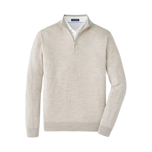 The Peter Millar Excursionist Flex Quarter-Zip Sweater in light beige Merino wool for men is shown layered over a white dress shirt, set against a plain white background.