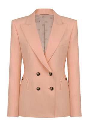 The Flica Charmer Blazer by Blaze Milano is a peach double-breasted blazer with wide lapels and gold buttons, crafted from a luxurious silk-linen blend. It features two front pockets and an interior with subtle print lining for equestrian-inspired elegance.