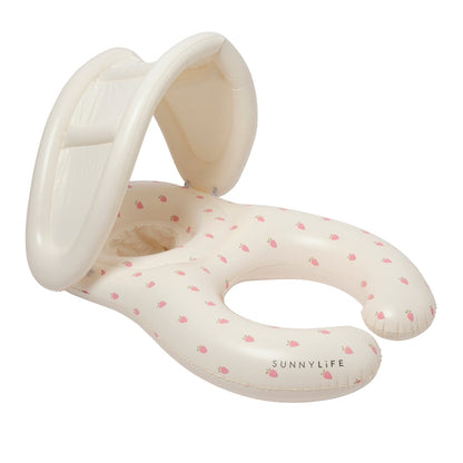 The SUNNYLIFE "Strawberry Sunshine Float Together Baby Seat" is an inflatable baby pool float with a built-in shade, designed in a light cream color and adorned with a small pink fruit pattern. This stylish swim seat provides comfort and protection for your little one as they enjoy the water.