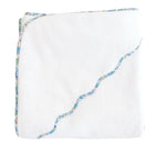 The Terry Tots Kids’ Scalloped Hooded Towel features a folded white design with a blue and pink floral trim and a wavy embroidered edge, making it an essential nursery accessory or baby towel, shown isolated on a white background.