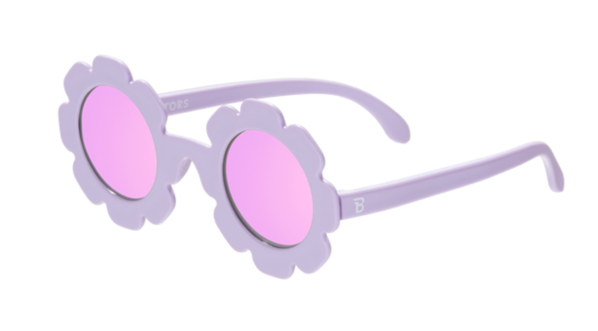 A pair of Babiators polarized flower-shaped sunglasses with purple frames and pink lenses.