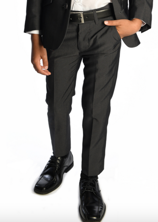 An individual dressed in a sleek black suit, with hands in pockets and sporting polished black shoes paired with Appaman's Boy's Mod Pant, ideal for a formal event.