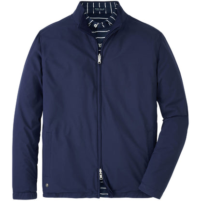 The Peter Millar Ryder Reversible Jacket, a navy blue water-resistant style with a high collar, is shown layered over a navy and white striped shirt.