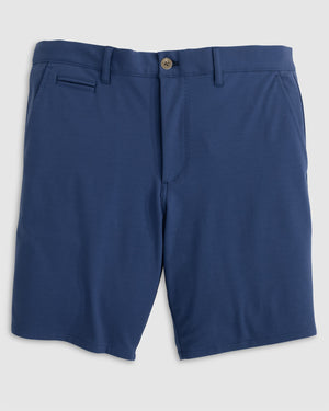 The Jupiters Short by Johnnie-O is a pair of blue men's golf shorts made from technical performance cotton, with a button closure, belt loops, front pockets, and a single welt pocket on the right side.