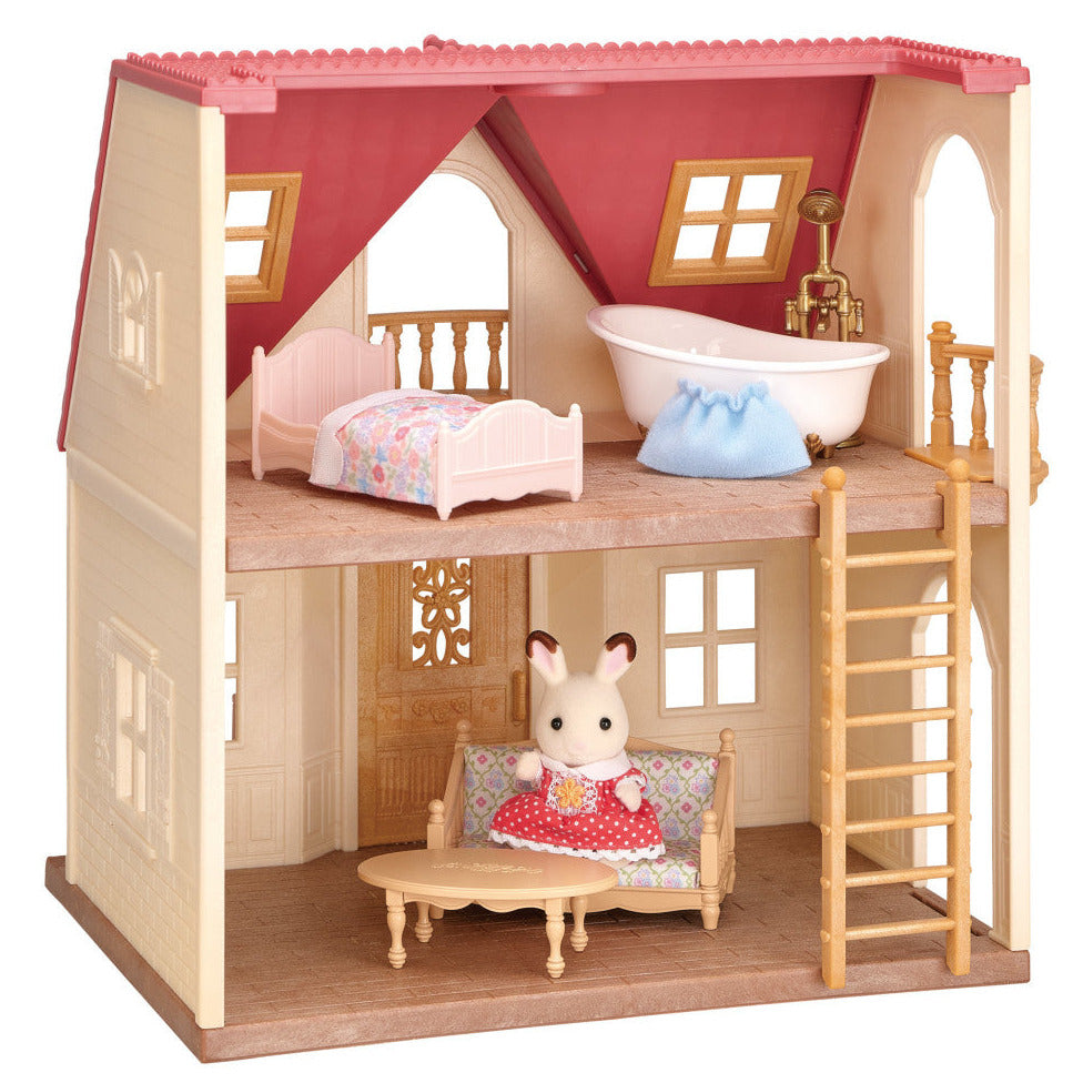 The Red Roof Cozy Cottage by Calico Critters is a miniature dollhouse with two floors, featuring a charming bedroom and bathroom upstairs and a cozy living room downstairs, where the included Chocolate Rabbit girl relaxes on the couch.