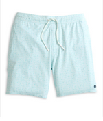 The Anemone Swim Trunks by Johnnie-O are light blue surf shorts made from a comfortable poly/spandex blend, featuring a subtle pattern, a white drawstring, and a small circular logo near the bottom hem on the left leg.