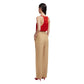 A woman stands with her back to the camera in a red sleeveless top, beige Renegade Fox Pants by Blaze Milano, and red heels against a white background.
