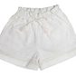 Early Sunday Girls’ Roman Shorts, crafted from breathable white cotton-linen with an elastic waistband, drawstring tie, tassel details, and lace trim near the hem, are displayed on a plain background.