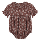 The Rylee & Cru Baby Girls’ Liv Romper features short ruffled sleeves, a ruffled collar, and an all-over white floral print on a brown background for a sweet vintage-inspired look.