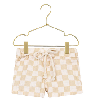 Lou Lou & Company Baby Boys’ Cloud Muslin Shorts in beige and white checkered print, featuring a relaxed fit and drawstring waist, displayed on a gold hanger against a white background.