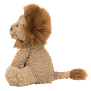 The Jellycat Fuddlewuddle Lion, Medium, is a plush toy with a textured beige body, large mane, and fluffy tail tip. It sits upright facing left against a white background.