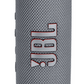 The JBL Flip 6 Waterproof Bluetooth Speaker in gray boasts a textured fabric surface and iconic logo, delivering powerful sound for any adventure.