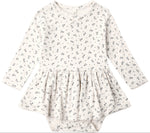 Introducing the Quincy Mae Baby Girls’ Pointelle Skirted Bodysuit—an off-white long-sleeve dress adorned with a delicate dark floral pattern. Featuring a gathered peplum skirt and practical snap closures at the bottom, this bodysuit blends comfort and charm in Quincy Mae’s signature style for little ones.