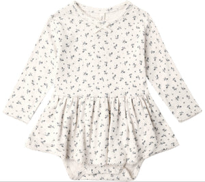 Introducing the Quincy Mae Baby Girls’ Pointelle Skirted Bodysuit—an off-white long-sleeve dress adorned with a delicate dark floral pattern. Featuring a gathered peplum skirt and practical snap closures at the bottom, this bodysuit blends comfort and charm in Quincy Mae’s signature style for little ones.