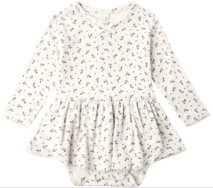 Introducing the Quincy Mae Baby Girls’ Pointelle Skirted Bodysuit—an off-white long-sleeve dress adorned with a delicate dark floral pattern. Featuring a gathered peplum skirt and practical snap closures at the bottom, this bodysuit blends comfort and charm in Quincy Mae’s signature style for little ones.