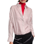 A person wears the Dorothee Schumacher Graphic Dreams Blouse—a relaxed fit, white silk twill shirt with a red geometric pattern—over a red turtleneck and black pants.