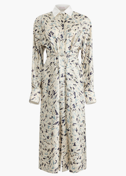 The Floyd Dress by Altuzarra is a long-sleeved, collared shirt dress with a belted waist, crafted from light fabric and adorned with an abstract blue and black animal pattern.