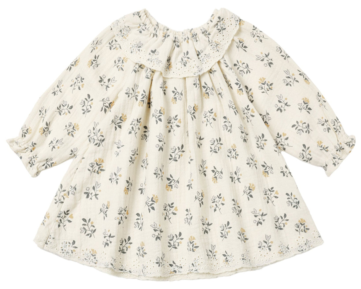 The Baby Girls’ and Girls’ Long Sleeve Isla Dress by Quincy Mae features a cream background with a delicate yellow and gray floral print, ruffled neckline, and lace-trimmed collar and hem. Expertly crafted from woven cotton, this dress offers timeless style and comfort.