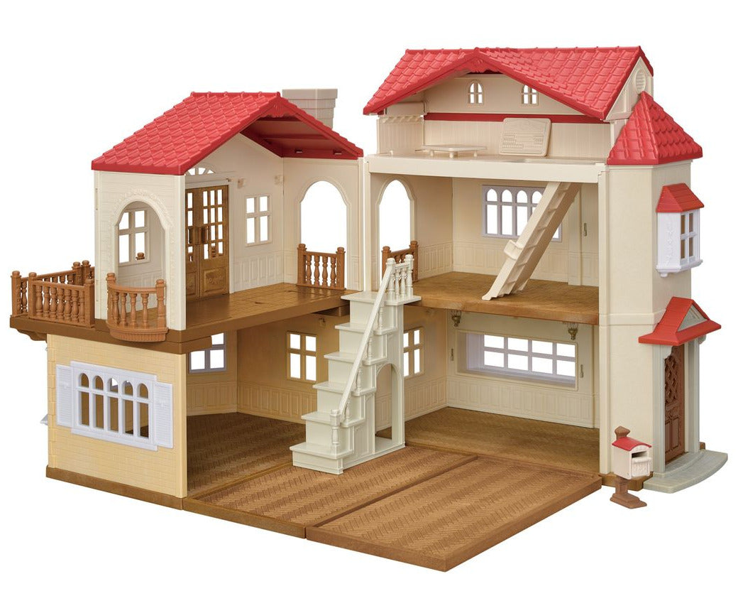 The Red Roof Country Home Gift Set by Calico Critters is a two-story dollhouse playset featuring charming red roofs, beige walls, stairs, balconies, spacious open rooms, and a small front-corner mailbox.