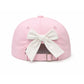 Bits & Bows Sister Bow Hat shown from the back, highlighting a white fabric bow above the adjustable tuckstrap and metal buckle—a charming nod to sisterhood.