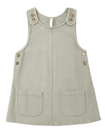 Girls’ Odette Overall Dress by Rylee & Cru in light gray, a sleeveless denim piece for toddlers with two front pockets and six metallic buttons on the shoulders and sides, shown laid flat on a white background.