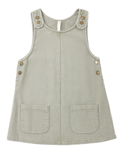 Girls’ Odette Overall Dress by Rylee & Cru in light gray, a sleeveless denim piece for toddlers with two front pockets and six metallic buttons on the shoulders and sides, shown laid flat on a white background.